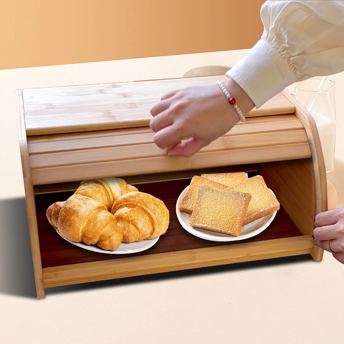 Opening the roll-top door of the bamboo bread box