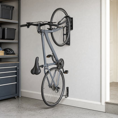 Grey bicycle hanging vertically from a black swivel wall mount in a tidy garage