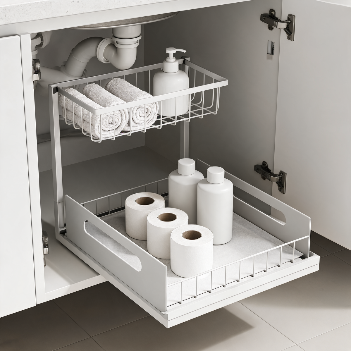 White slide-out organizer under a bathroom sink holding washcloths and toilet paper rolls