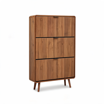 Walnut slim shoe cabinet with three fluted flip drawers and tapered legs on a white background