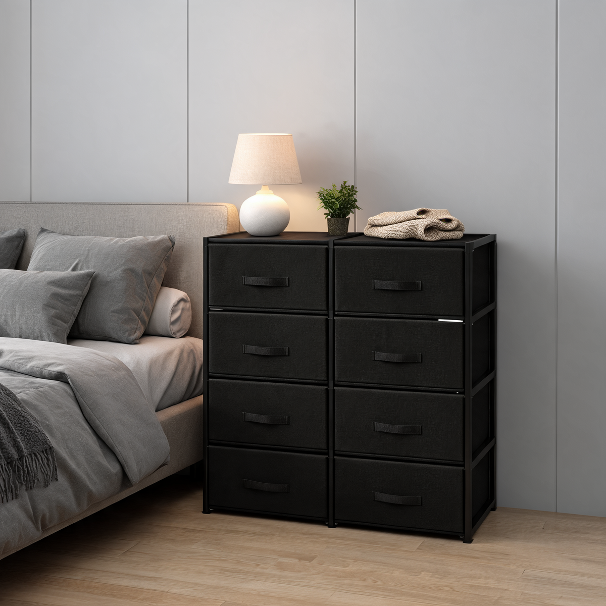 Black 8-drawer fabric chest used as a dresser beside a bed