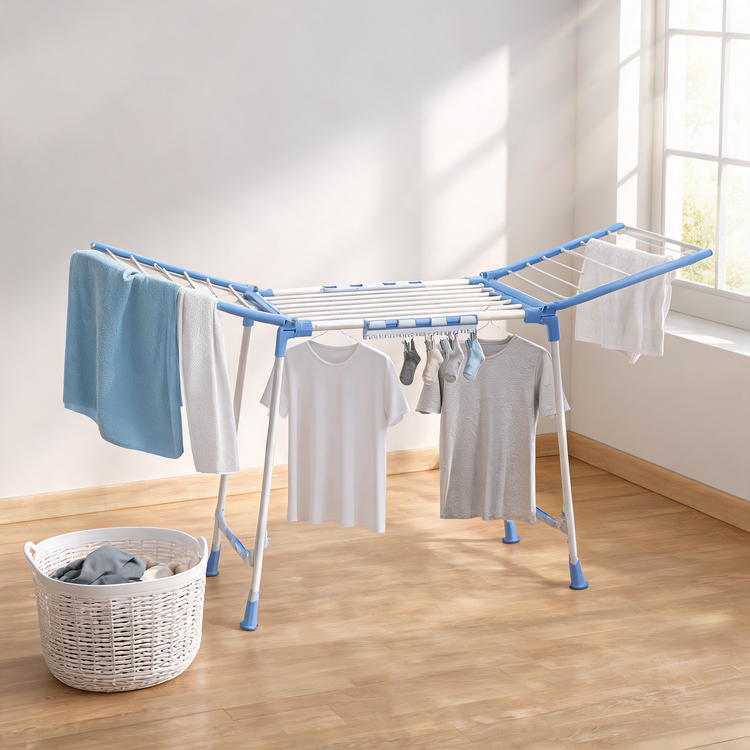 Blue drying rack with towels and T-shirts in a sunny laundry room