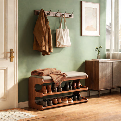 Shoe storage bench with shoes on two shelves in a sage green hallway