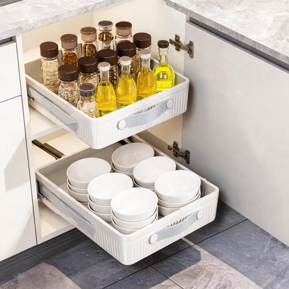 White pull-out cabinet organizers holding spices and bowls in a kitchen cabinet