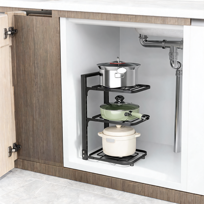 Black 3-tier pot rack holding pots and a pan in a kitchen cabinet