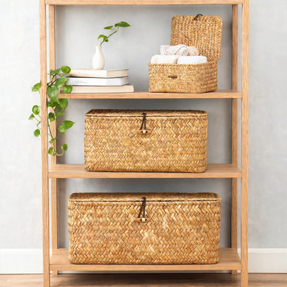 Three seagrass storage baskets with lids on oak shelving