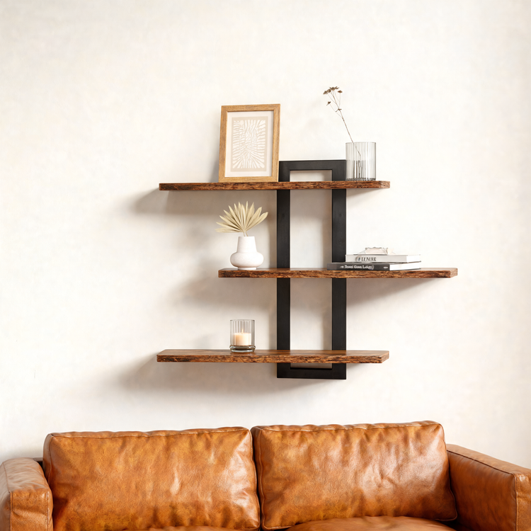 3-tier wall shelf with black frame above a leather sofa