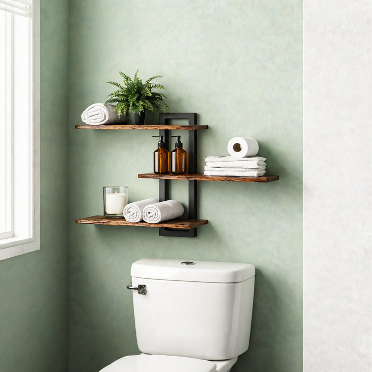3-tier wall shelf holding towels and plants above a toilet